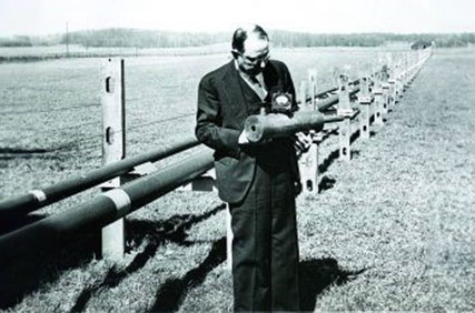 Figure 2 image of george southworth standing in front of an experimental waveguide 